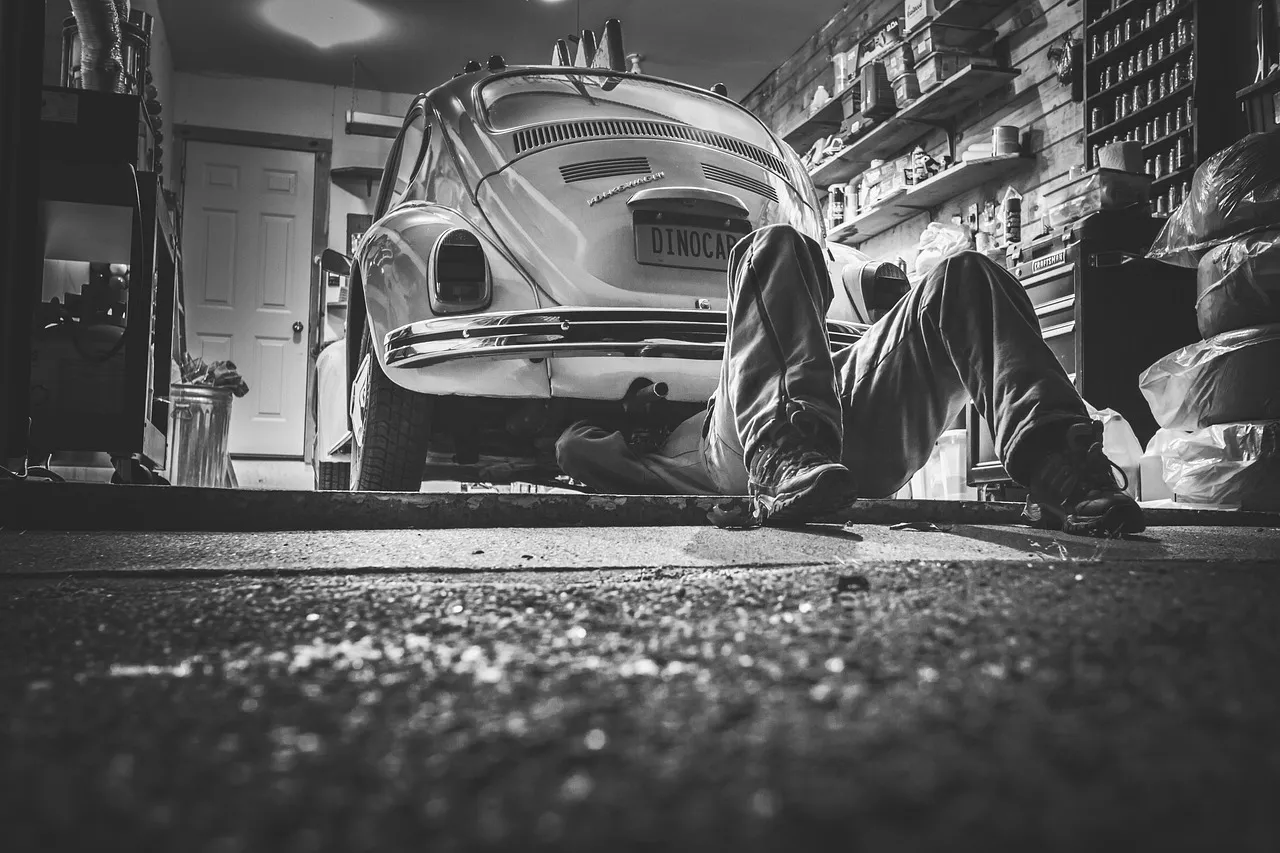 A man working on a car engine during a repair.